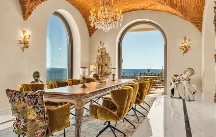 Villa dining room with a vaulted brick ceiling and sea view